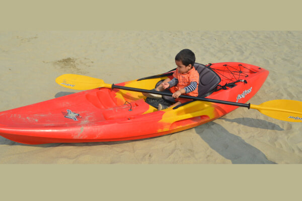 My Kid with a Kayak in a local beach 1
